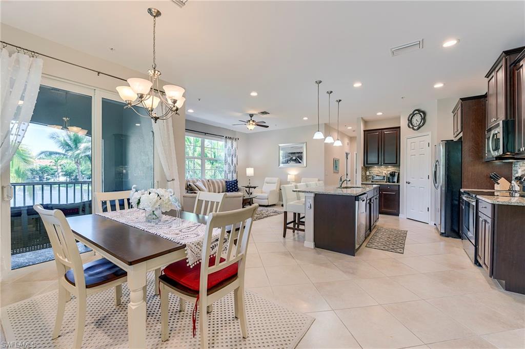 Dining space featuring ceiling fan, a chandelier, light tile patterned floors, and recessed lighting