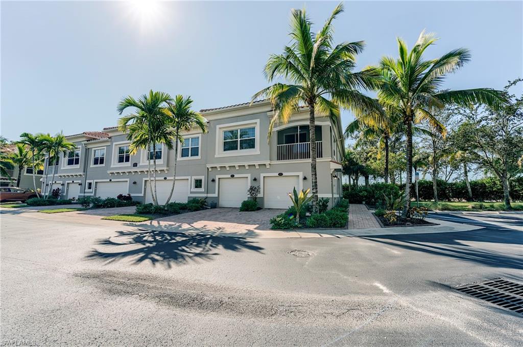 Mediterranean / spanish house with an attached garage, driveway, stucco siding, and a balcony