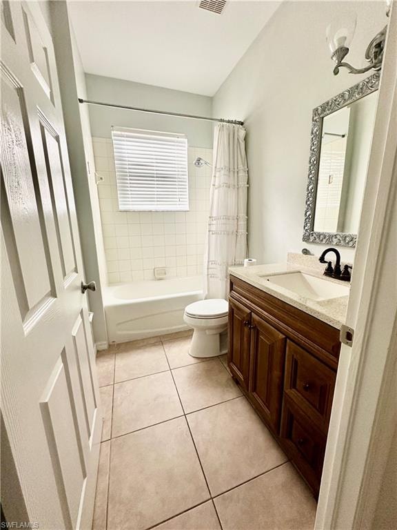 Full bathroom featuring vanity, tile patterned flooring, shower / bathtub combination with curtain, and toilet