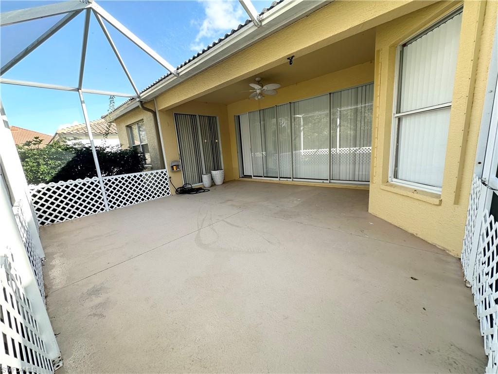View of patio / terrace with ceiling fan and glass enclosure