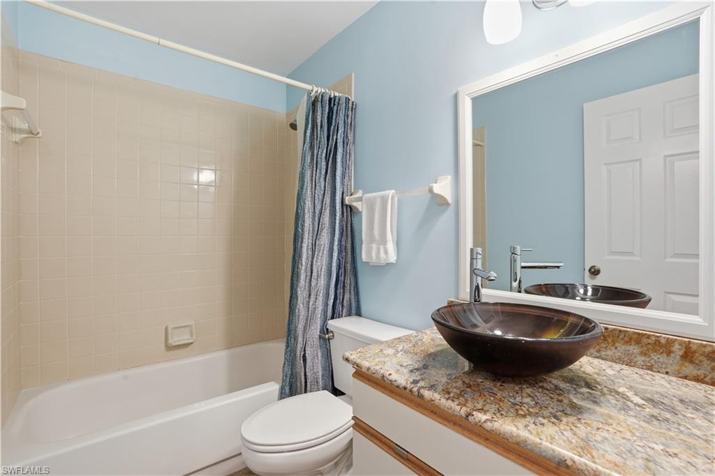 Full bath featuring vanity and shower / tub combo with curtain