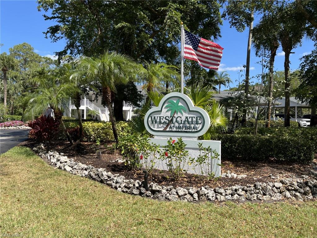 Community / neighborhood sign with a yard