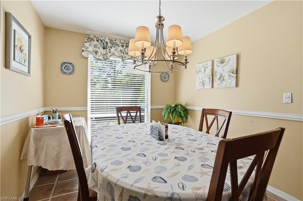 Dining space with a chandelier and baseboards