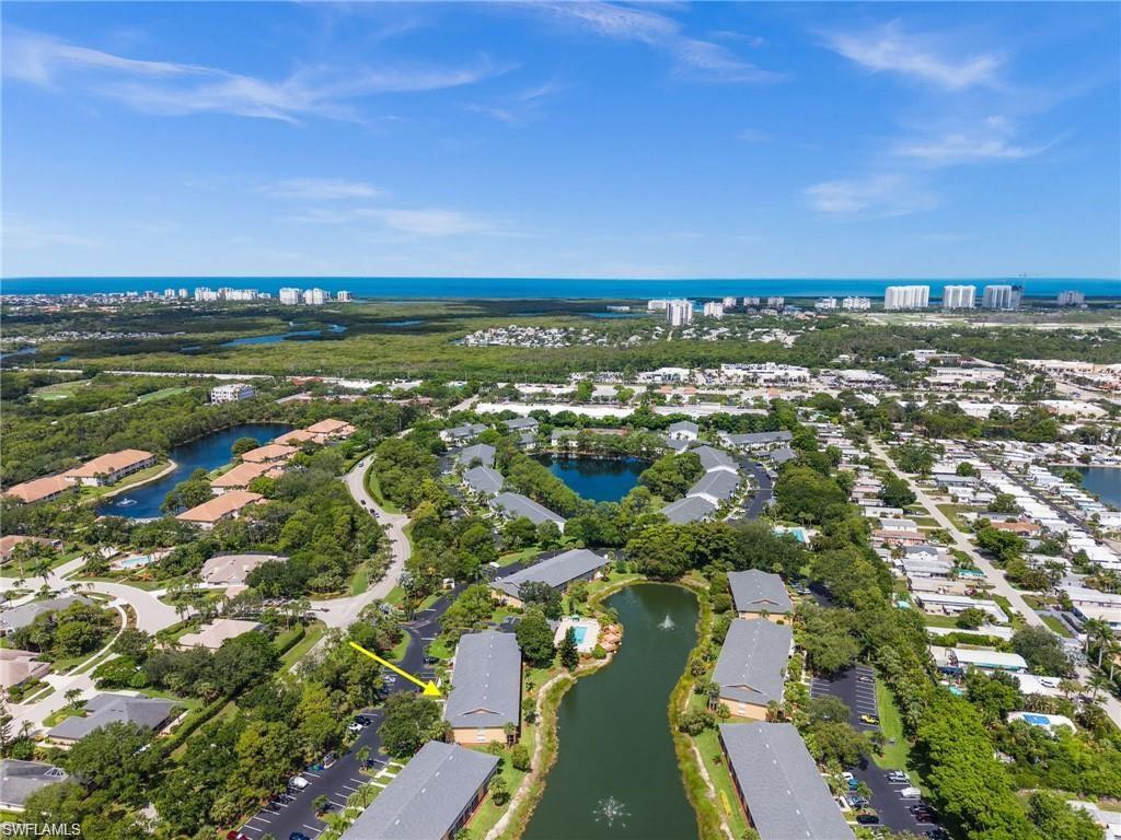 Aerial overview of property's location with a nearby body of water and nearby suburban area