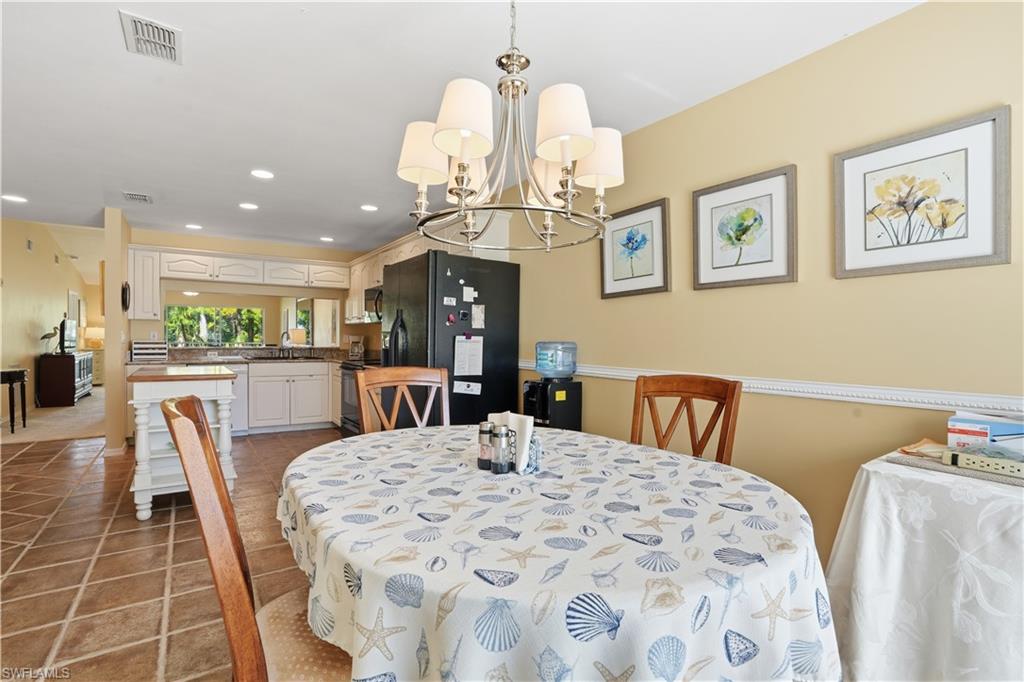 Dining area featuring a chandelier, recessed lighting, and light tile patterned floors