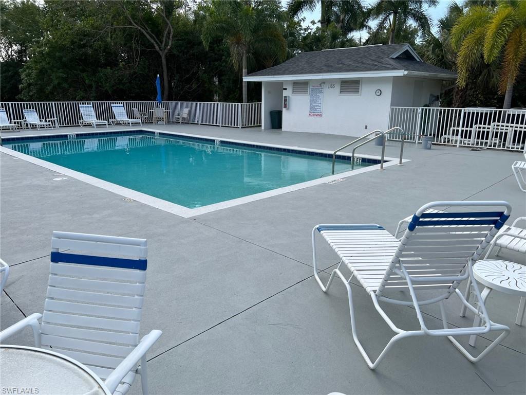 Community pool with a patio