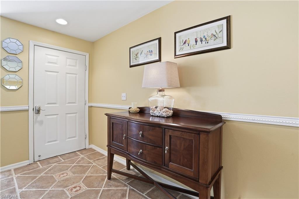 Entryway with light tile patterned floors and baseboards