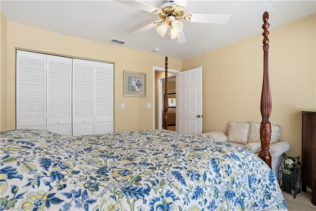 Bedroom featuring carpet, ceiling fan, and a closet