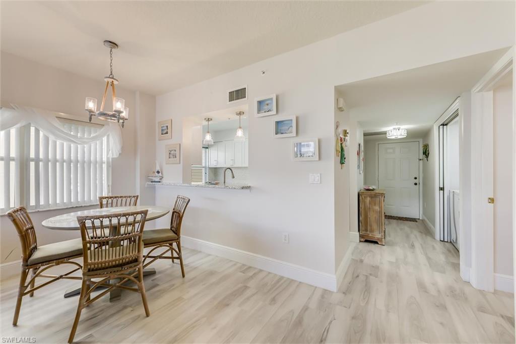 Dining room featuring light wood-type flooring and a chandelier