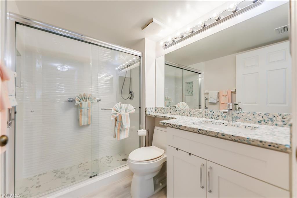 Bathroom with a stall shower and vanity