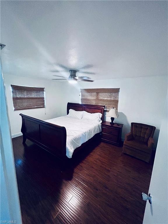 Bedroom with dark wood-style floors and a ceiling fan