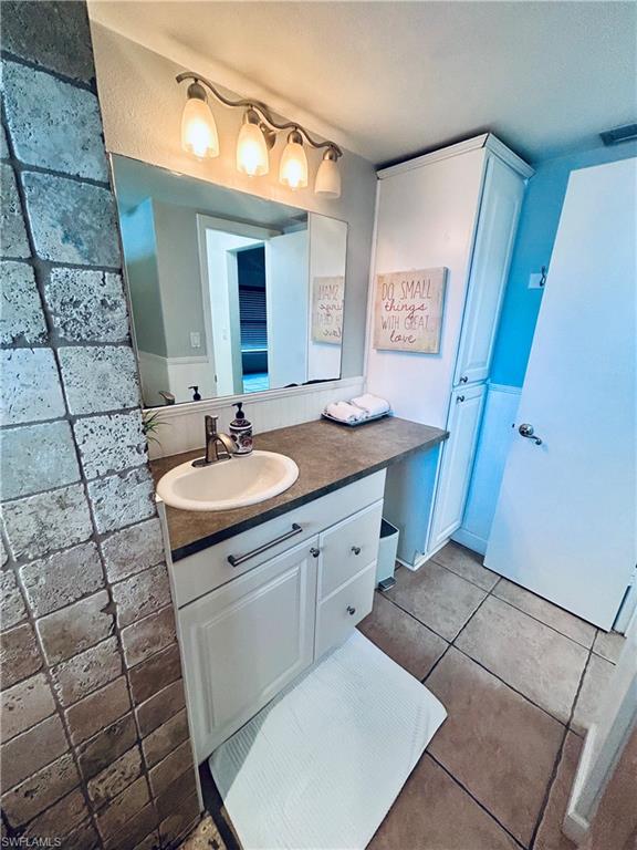 Bathroom with vanity and light tile patterned floors