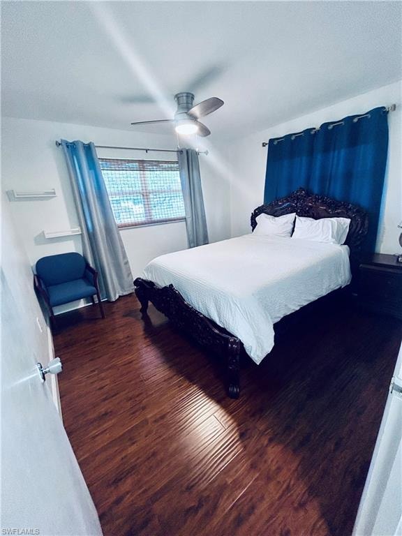 Bedroom featuring dark wood finished floors, ceiling fan, and a textured ceiling