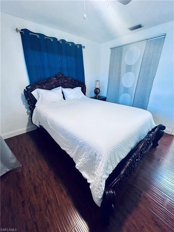 Bedroom featuring dark wood-type flooring and a ceiling fan