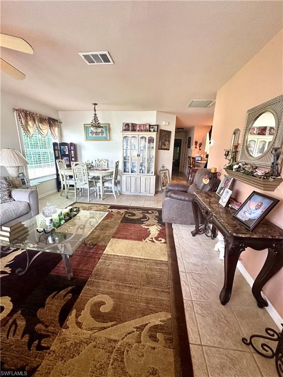 Living area featuring tile patterned flooring and baseboards