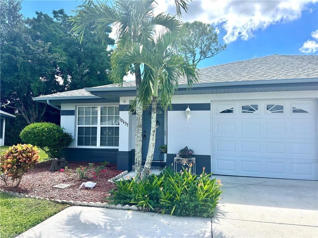 Ranch-style home featuring stucco siding, driveway, an attached garage, and a shingled roof