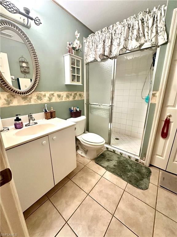 Full bathroom featuring a stall shower, vanity, and light tile patterned floors
