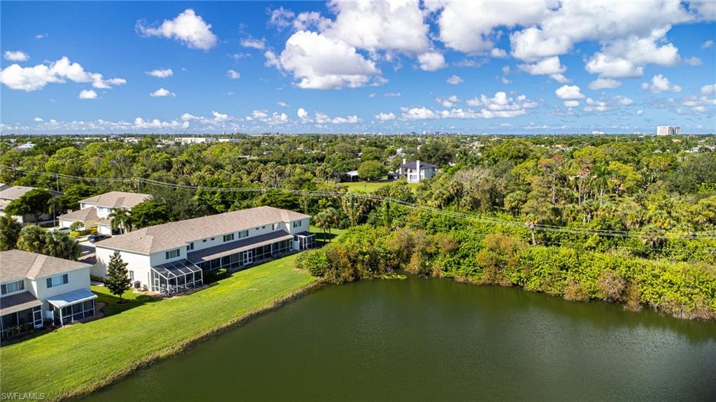 Aerial view of property and surrounding area featuring a large body of water