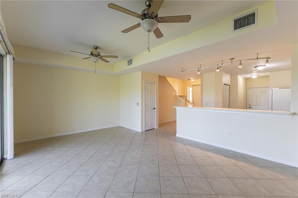 Spare room with light tile patterned flooring and ceiling fan