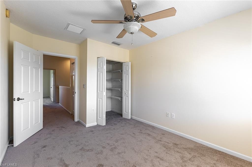 Unfurnished bedroom featuring carpet and a ceiling fan