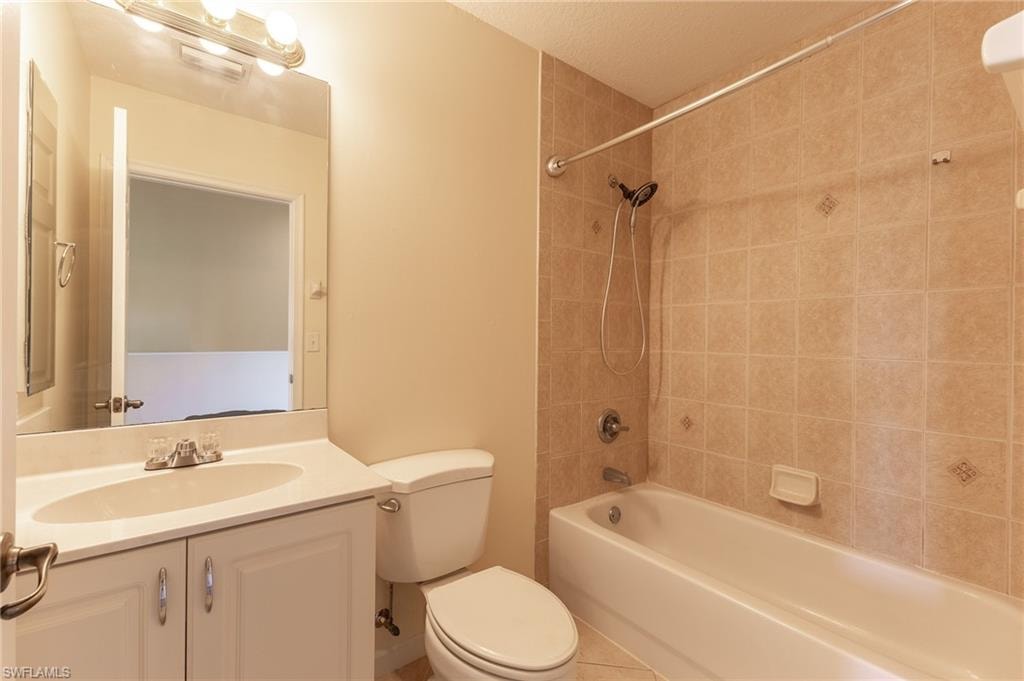 Full bathroom featuring bathtub / shower combination, vanity, and tile patterned flooring