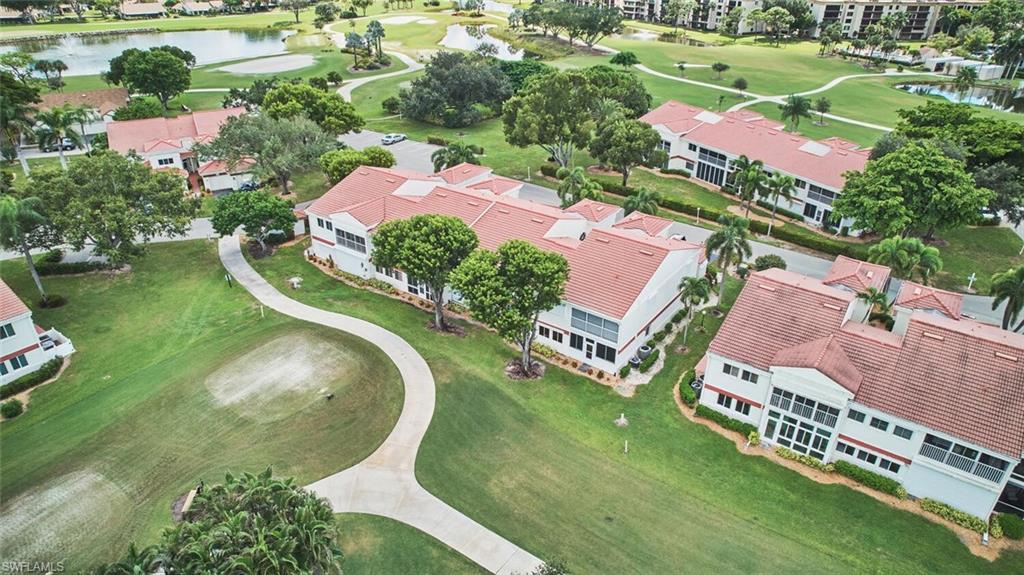 Aerial view of property's location with a golf club and a nearby body of water