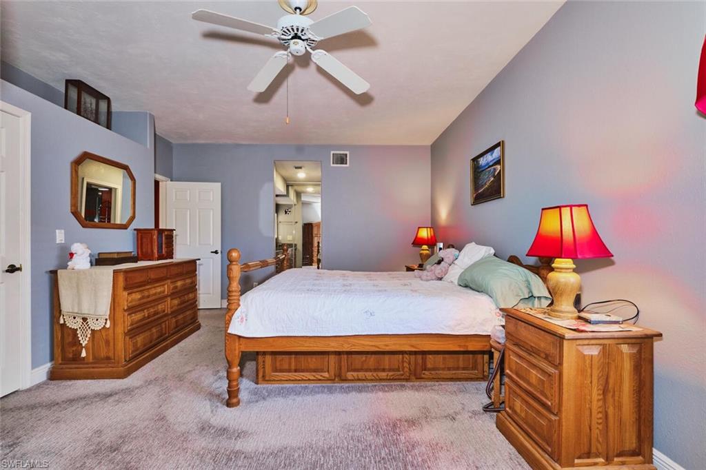 Spacious Primary bedroom featuring ceiling fan and walk-in closet