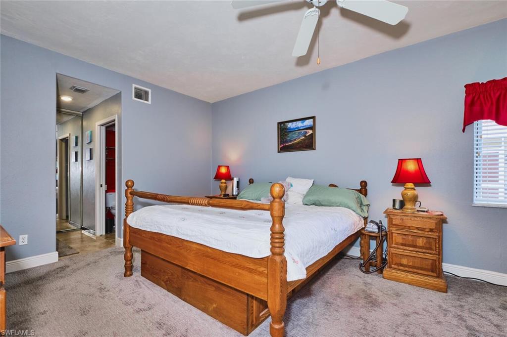 Bedroom featuring a ceiling fan and carpet floors