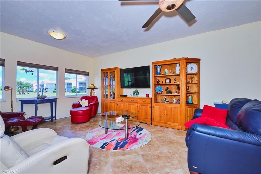 Living area featuring light tile floors and a view of Golf Course