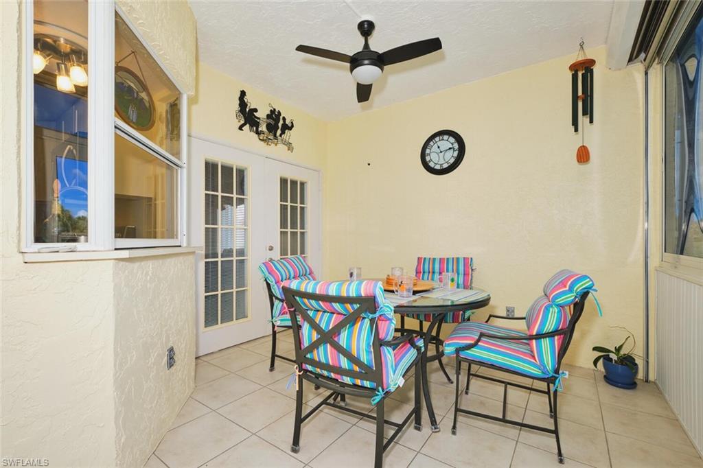 View of patio / terrace with ceiling fan, french doors, and outdoor dining space