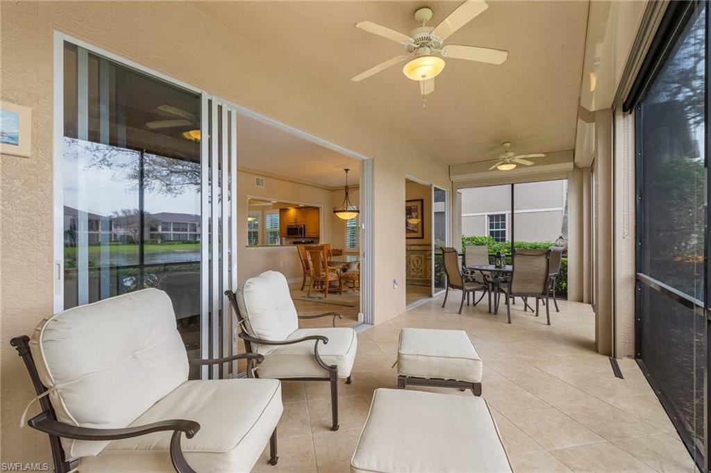 Sunroom / solarium with outdoor dining area, a ceiling fan, and a patio