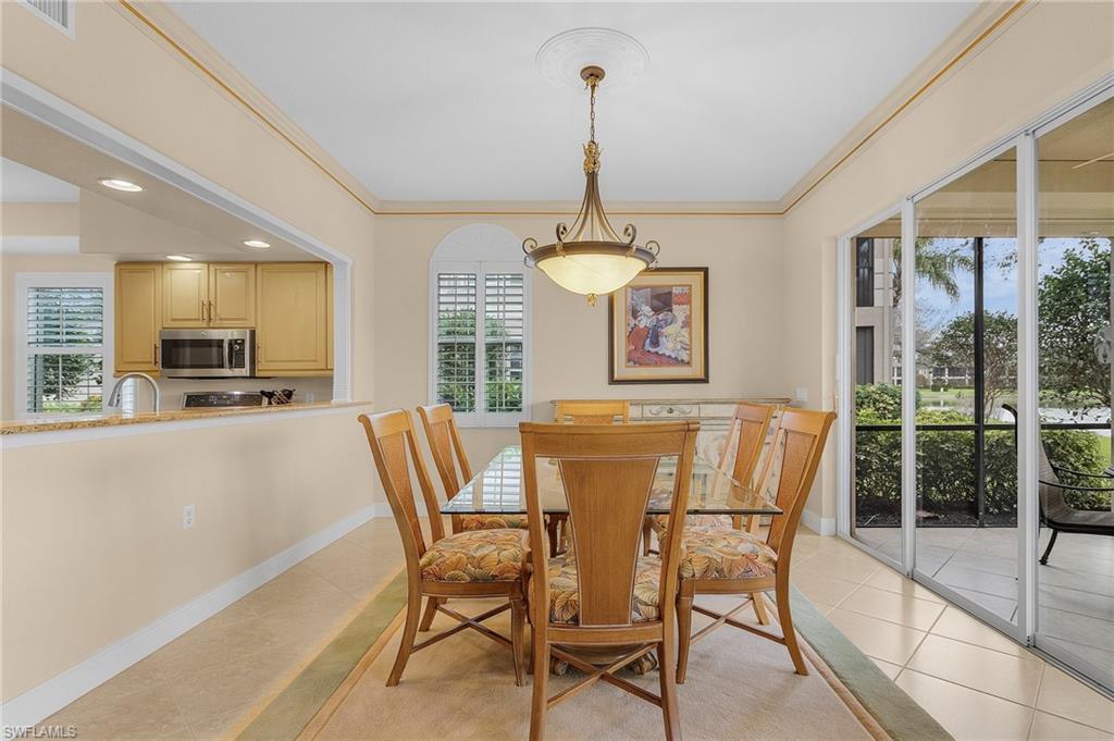 Dining room featuring light tile patterned floors, ornamental molding, and recessed lighting