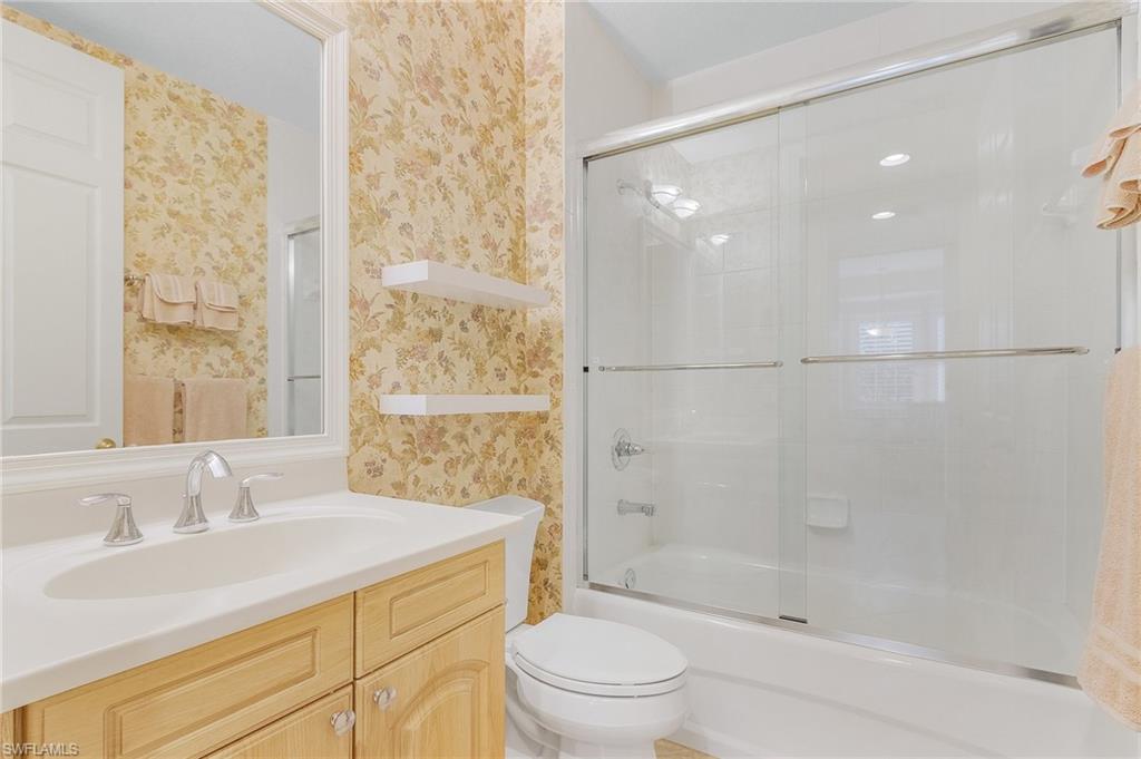 Full bathroom featuring combined bath / shower with glass door and vanity