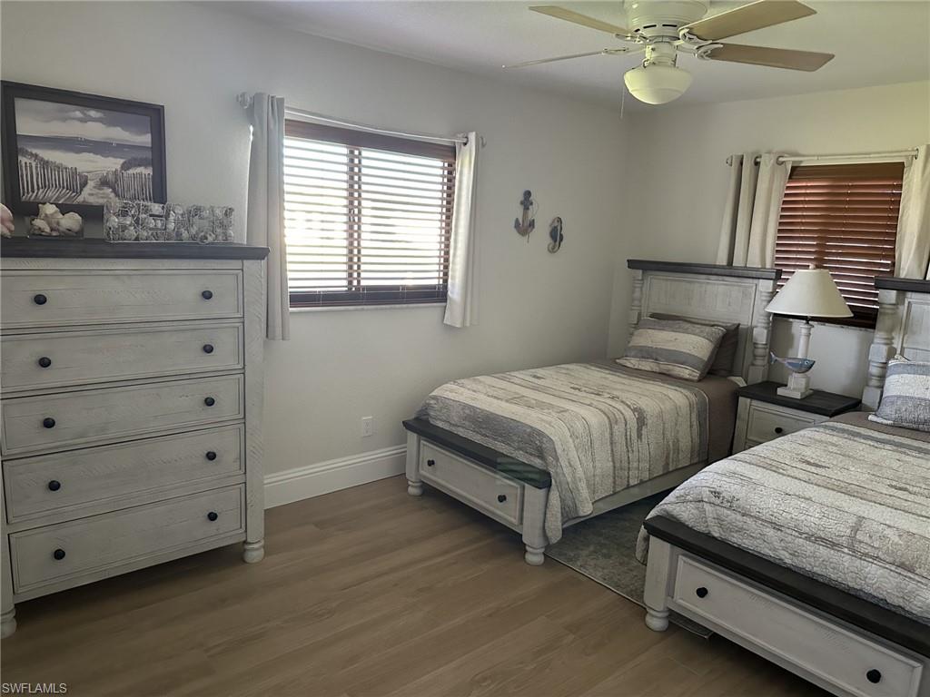 Bedroom featuring dark wood-style floors and a ceiling fan