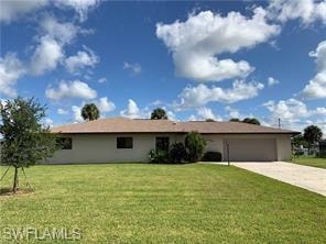 Ranch-style house with a front yard, driveway, and an attached garage