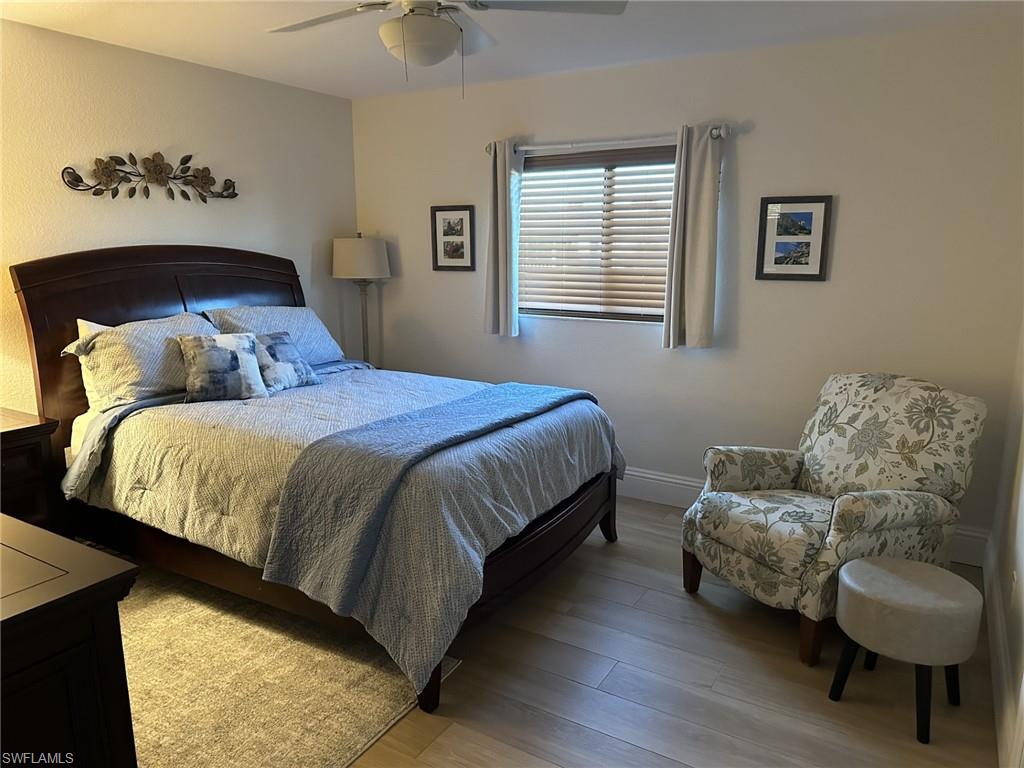 Bedroom with wood finished floors and a ceiling fan
