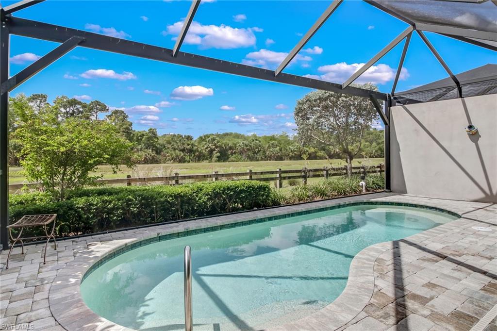 View of swimming pool featuring a lanai and a patio area