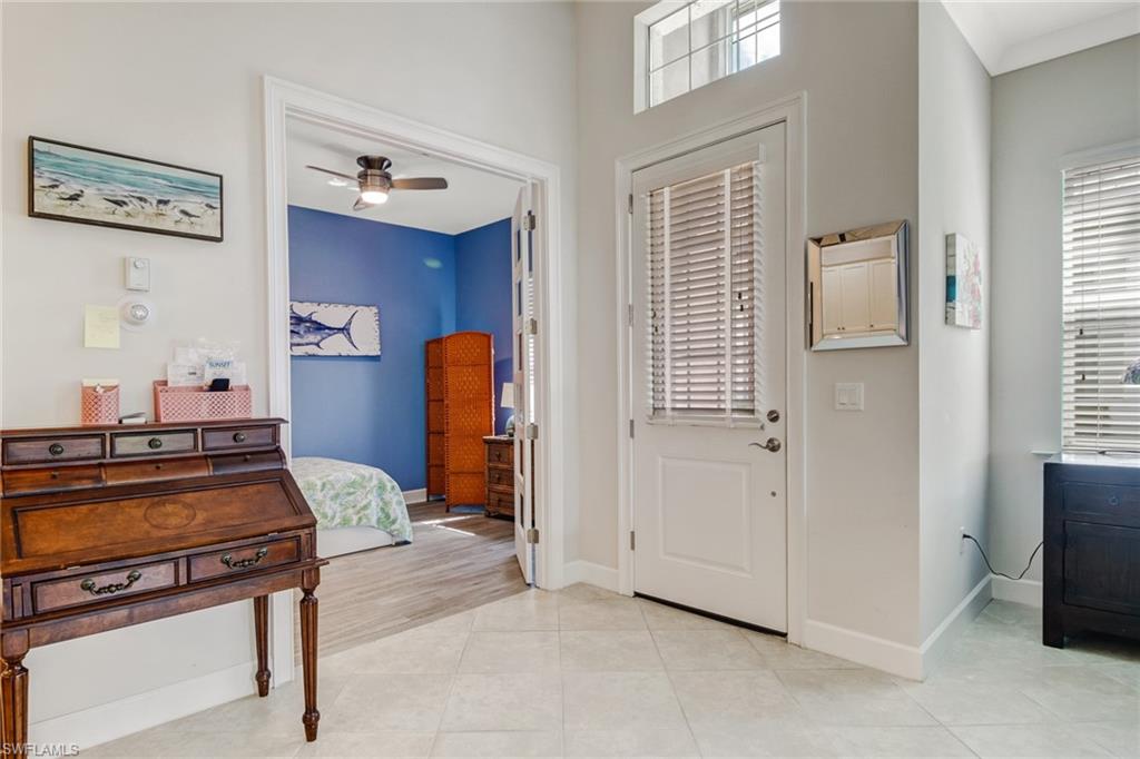 Tiled entryway featuring ceiling fan