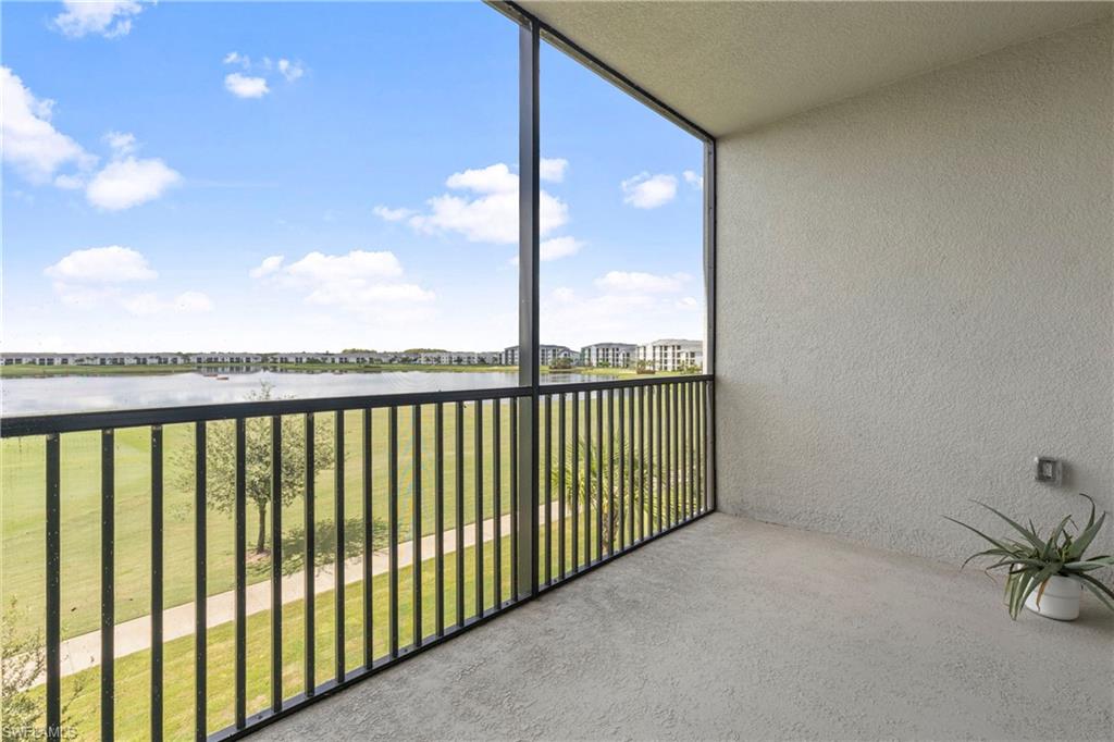 Balcony featuring a water view and a sunroom
