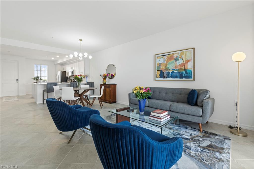 Living area featuring a chandelier and light tile patterned floors