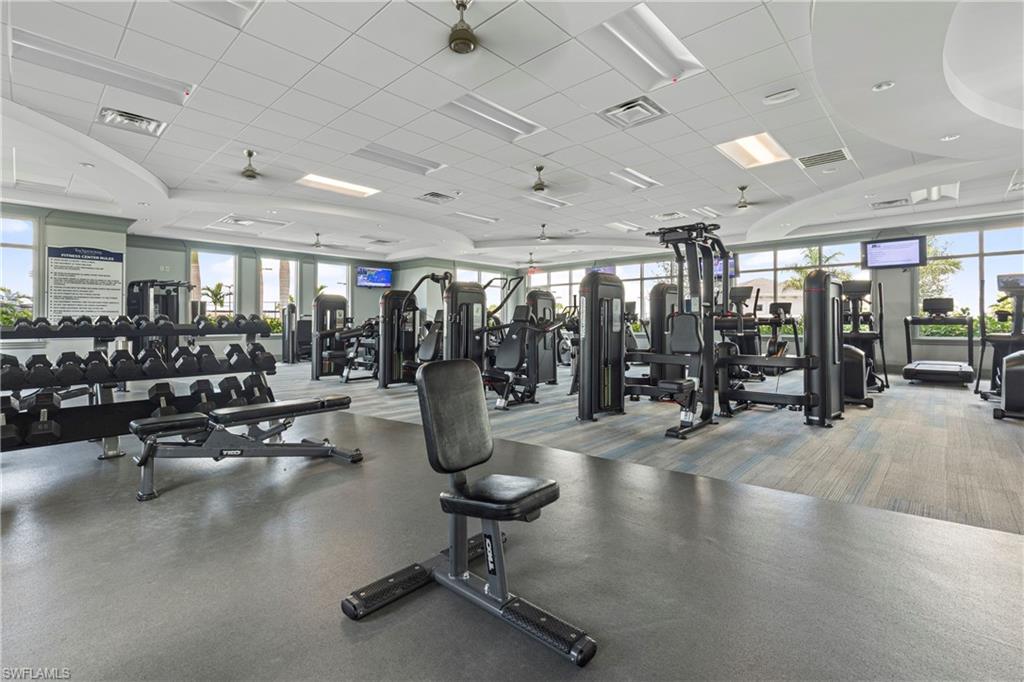 Exercise room featuring a paneled ceiling and a ceiling fan