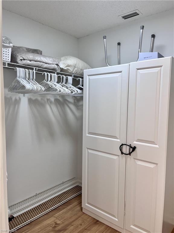 Spacious walk in closet with built-in shelving