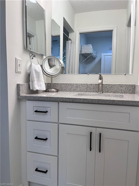 Bathroom featuring vanity and a textured ceiling