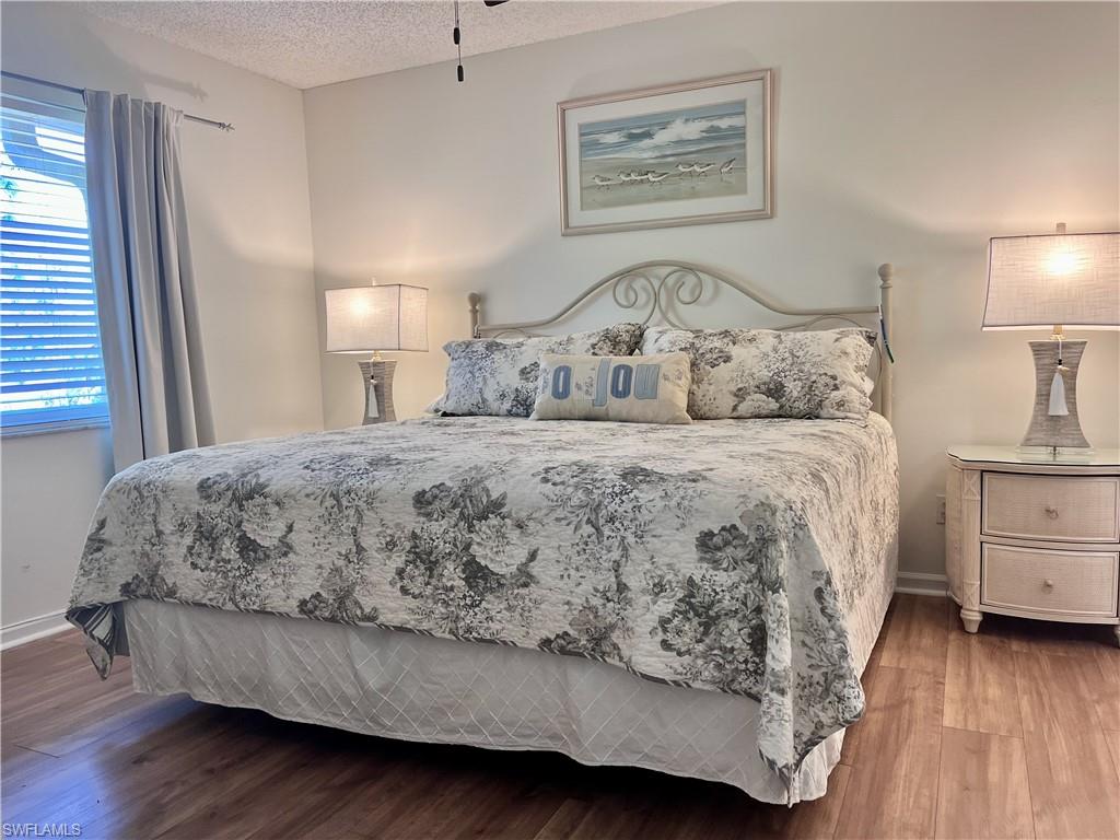 Bedroom featuring a textured ceiling and hardwood / wood-style floors