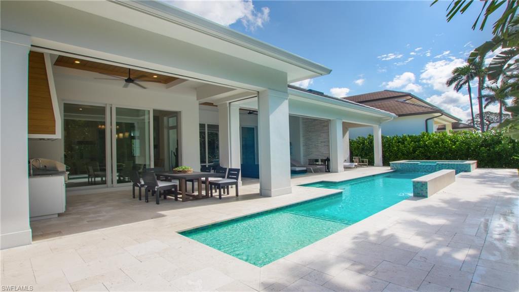 View of pool with a patio area and ceiling fan