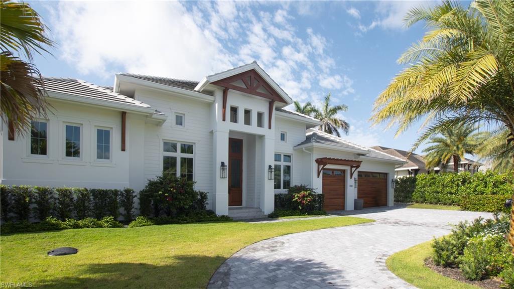 View of front of house with a garage and a front lawn