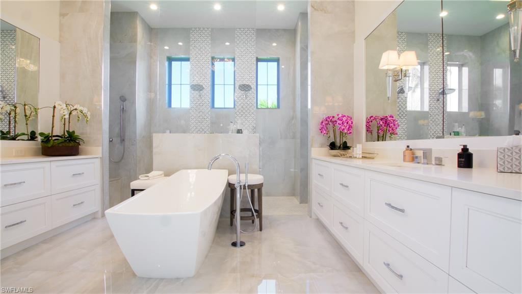 Bathroom with independent shower and bath, vanity, tile patterned flooring, and tile walls