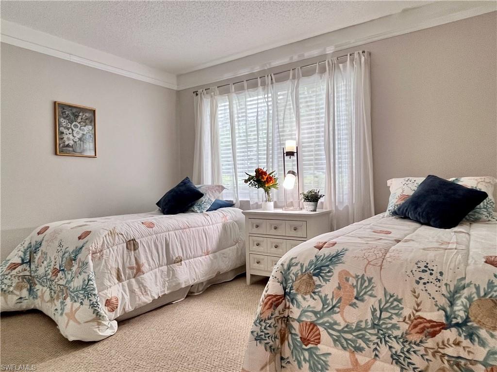 Guest Bedroom with carpet, crown molding and large window for lots of natural light.