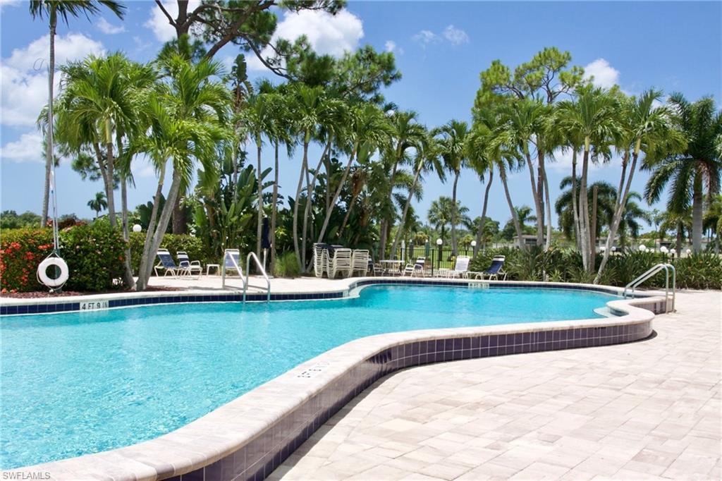 Main Community pool featuring a patio area ajacent to the course and the 19th hole