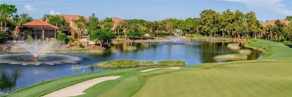 View of community featuring a water view, golf course view, and view of scattered trees